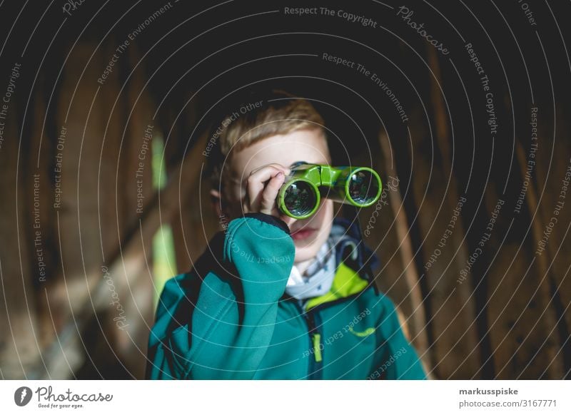 Boy looks through binoculars Leisure and hobbies Playing Adventure Far-off places Freedom Garden Parenting Education Kindergarten Child Human being Masculine