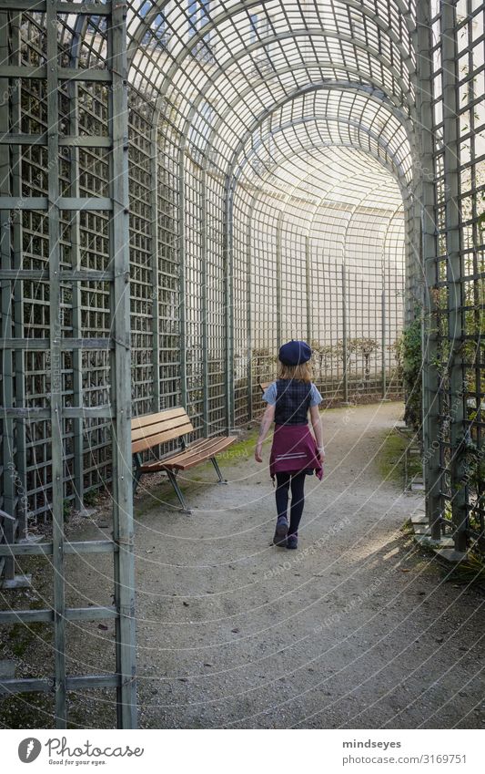 A girl walks through a park Tourism City trip Girl Infancy 3 - 8 years Child Park Paris Grating Arcade Park bench Fashion Beret Blonde Observe Discover Going