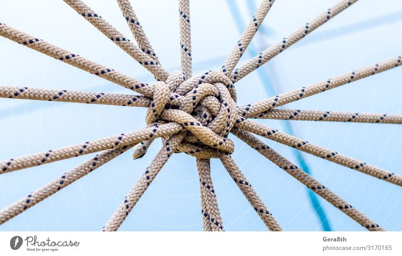 lots of ropes and a big knot against the blue sky Climbing Mountaineering Cable Tool Rope Blue Insurance background Blank blue sky sky connected ropes equipment