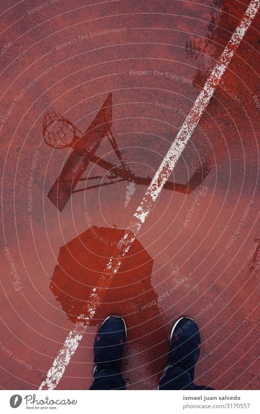 basketball hoop reflection on the puddle on the ground Basketball Reflection Water Puddle Rain Ground Court building Playing field Story Sports Abandon Street