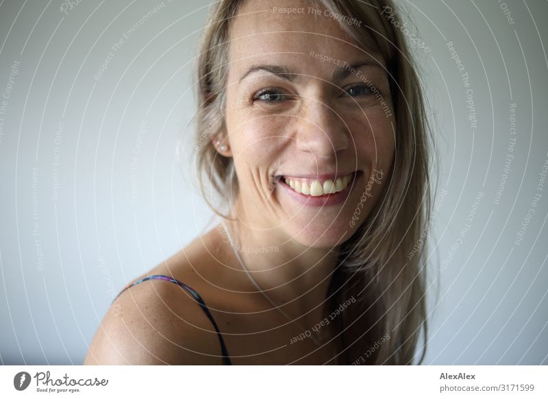 Portrait of a smiling woman with long blond hair Style Joy pretty Life Well-being Woman Adults Face 30 - 45 years Blonde Long-haired Freckles Smiling Laughter