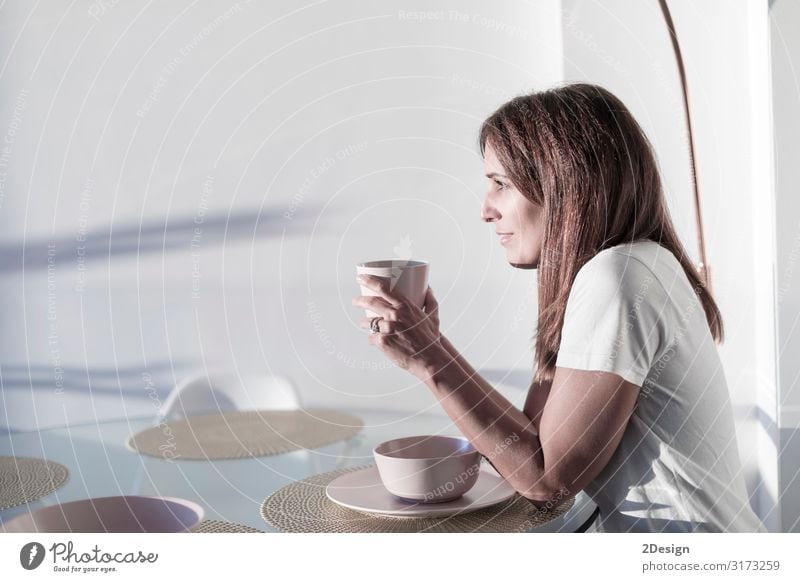 woman sitting on living-room while holding a cup of tea Breakfast Beverage Drinking Hot drink Coffee Tea Lifestyle Happy Beautiful Relaxation