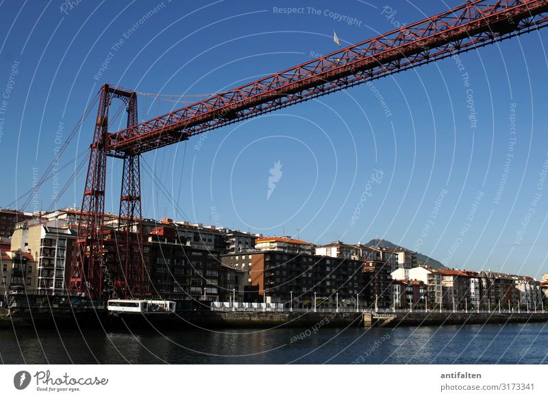 Puente de Vizcaya bridge floating ferry Vacation & Travel Red vantage point piers steel framework Blue sky Sun Weather Trip Spain UNESCO World Heritage Site