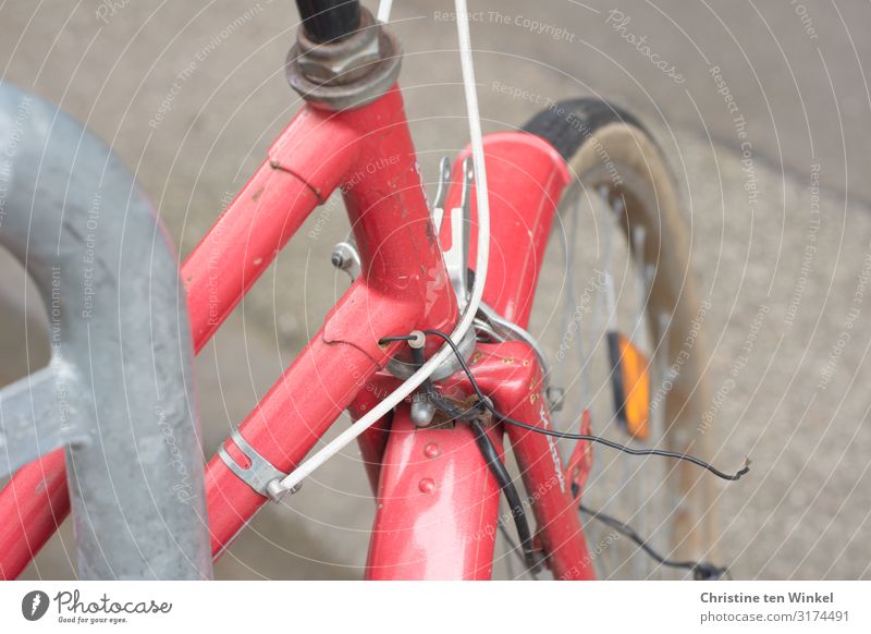 red bike Bicycle Old Authentic Glittering Broken Retro Town Red Mobility Perspective Environment Colour photo Multicoloured Exterior shot Close-up Detail