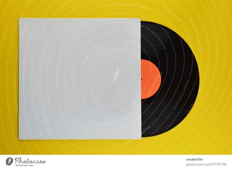 old black vinyl record half in neutral white record sleeve on yellow background | old Record LP Ancient Retro vintage Music cover Sheath Record sleeve Yellow