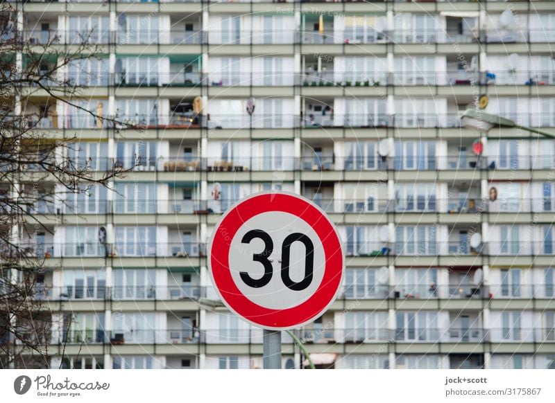 Façade blurred at 30 km/h Winter Branch Schöneberg Prefab construction Tower block Facade Road sign Speed limit Authentic Gloomy Orderliness Modern Road safety