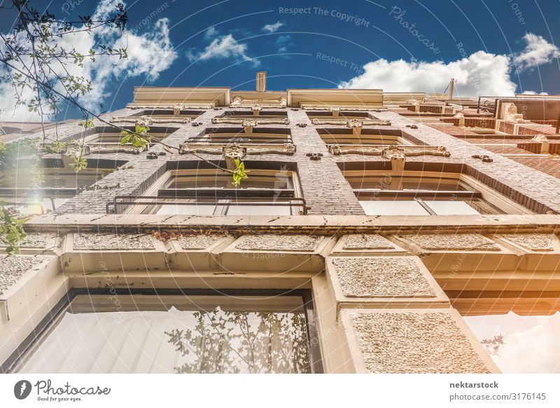 Stone Building Exterior Wall Details in Amsterdam Elegant Beautiful Sky Clouds Architecture Facade Old Tall Classic masonry window sunny directly below