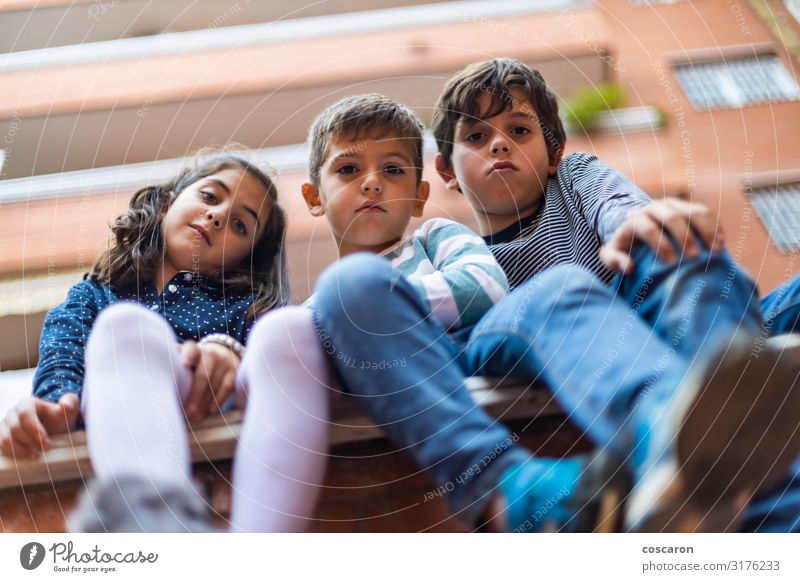 Three bad boys sitting on the neighborhood Lifestyle Joy Happy Beautiful Summer Living or residing House building Child School School building Schoolchild