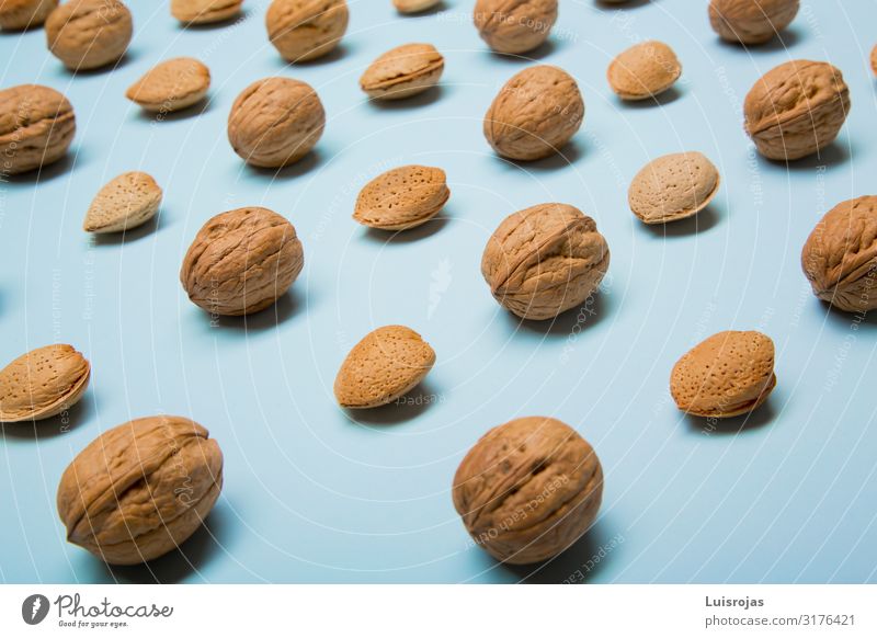 Still life with nuts and almonds on blue background Food Fruit Nutrition Eating Organic produce Vegetarian diet Diet Design Autumn Warmth Brown Yellow