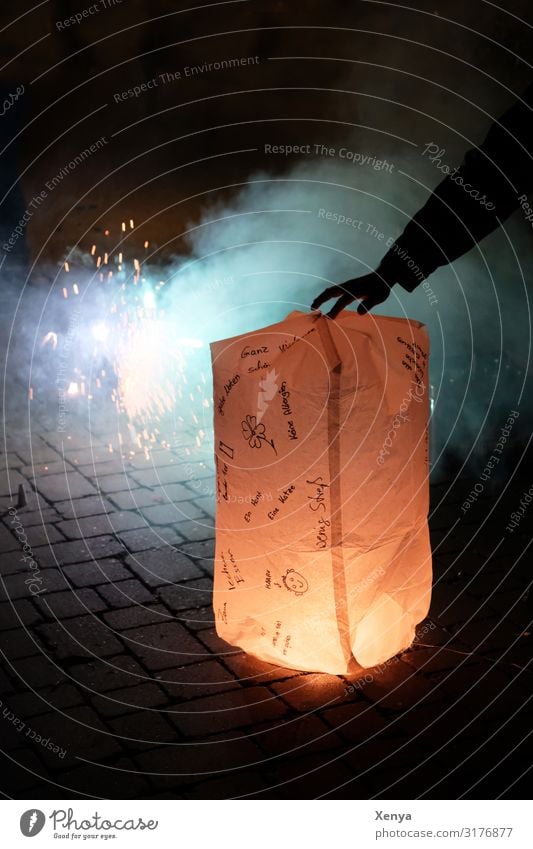 New Year's Eve lantern Masculine Arm Hand 1 Human being Winter Places Blue Brown Yellow Black White Lampion sky lantern Chinese lantern Congratulations Smoke