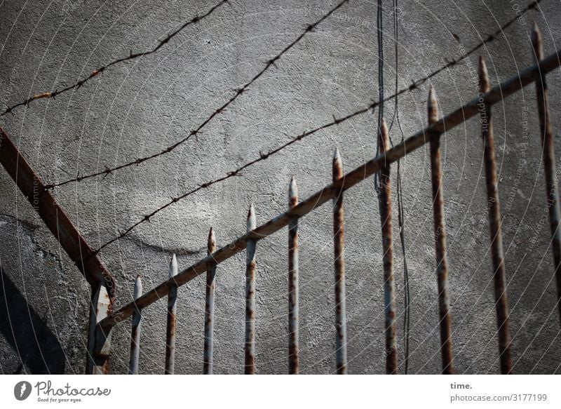 Stories from the fence (IV) | Weltschmerz Lisbon Wall (barrier) Wall (building) Fence Barbed wire Rust Wire Point Stone Metal Line Stripe Network Historic Gray