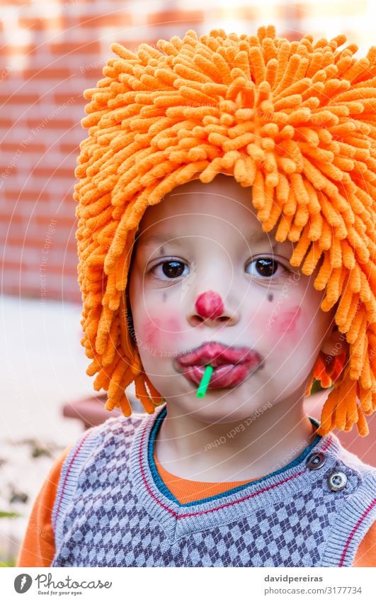 Clown child eating lollipop in party Dessert Eating Joy Happy Face Make-up Playing Entertainment Feasts & Celebrations Birthday Child Boy (child) Infancy Teeth