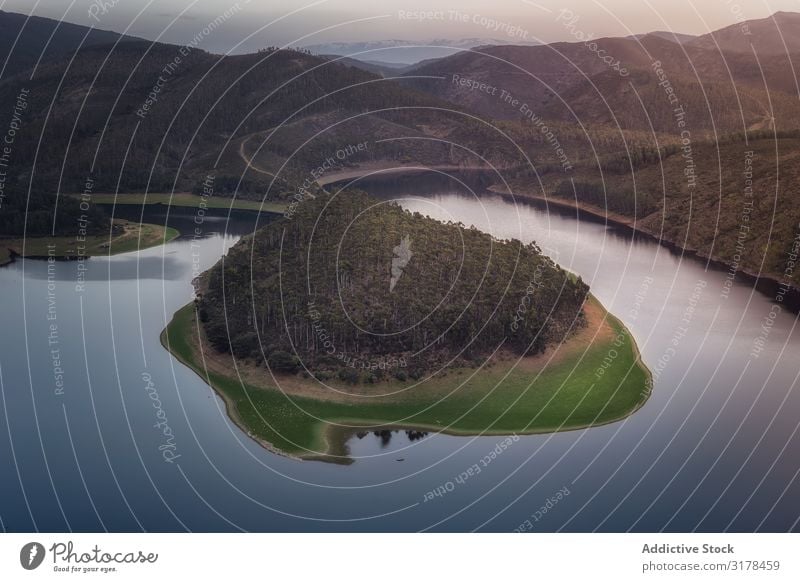 Small island on lake in mountain landscape Island Lake Mountain Wood Landscape drone view terrain loch Deserted Undulating Smooth Forest Surface Water