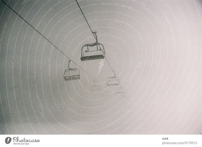 Chairlift in the fog Fog Winter chair lift Ski lift Ski resort Closed foggy Dreary Gloomy Cold Copy Space poor visibility Landscape Bad weather Snow Weather