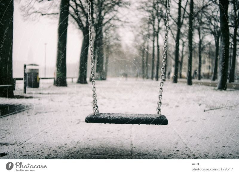 Deserted playground in winter Winter Playground Swing Theresienwiese Munich Exterior shot Snow Loneliness Calm Cold Infancy Colour photo Park Gloomy To swing