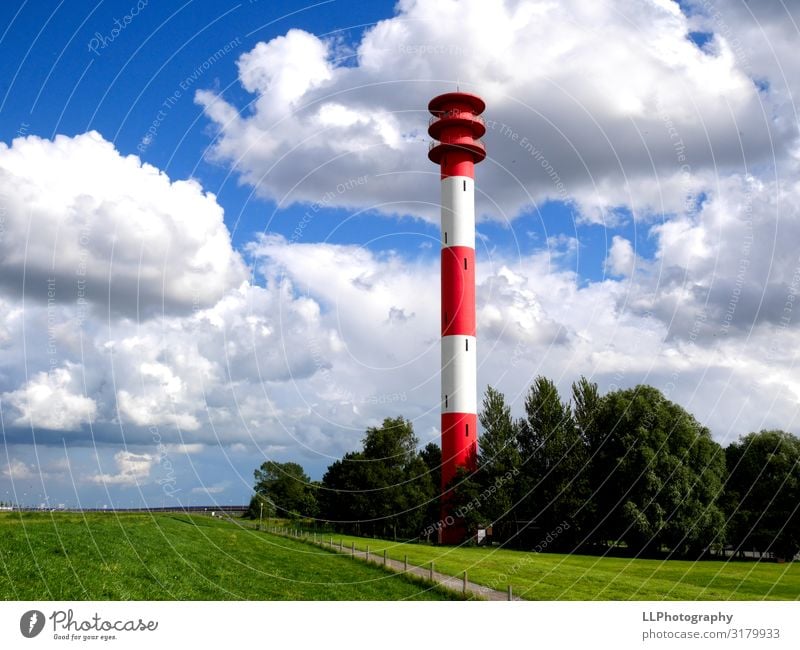 Beaming lighthouse Aquatics Sailing Landscape Clouds Gale Coast North Sea Port City Illuminate Dream Blue Red White Jadebusen Colour photo Exterior shot