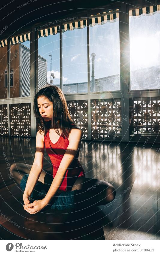 Content woman flexing body in studio Woman Dancer Studio shot Warming up stretch Sit Relaxation Flexible Athletic Concentrate Practice Interior shot Ballet