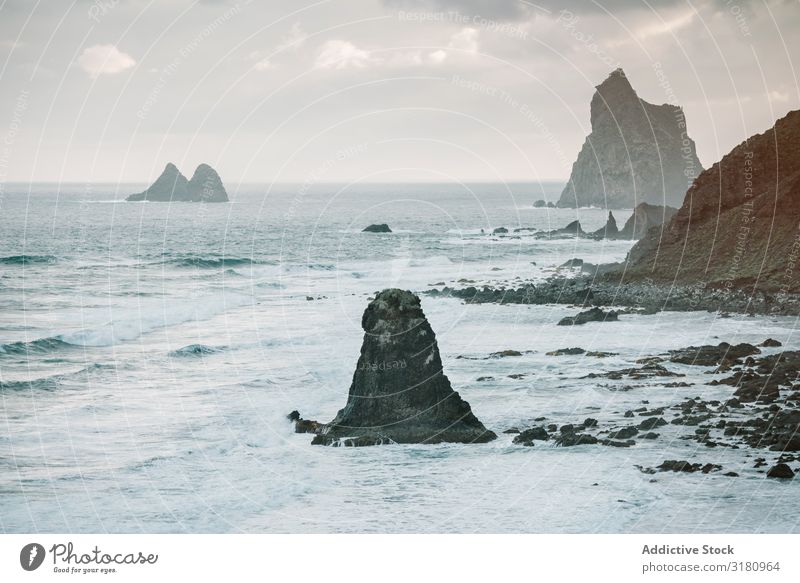 Lonely cliff in sea on cloudy day Cliff Ocean Clouds Sky Vantage point playa benijo Tenerife Spain Landscape Nature Vacation & Travel Water Rock Trip Deserted