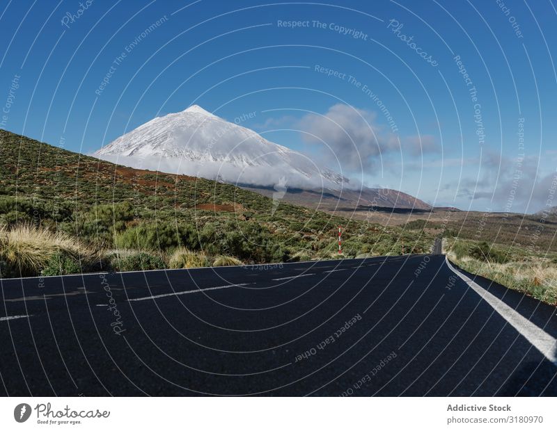 Countryside road near snowy mountain peak Street Landscape Mountain Peak Snow Canaries Spain terrain Sunbeam Day Sky Clouds Deserted Vacation & Travel Trip