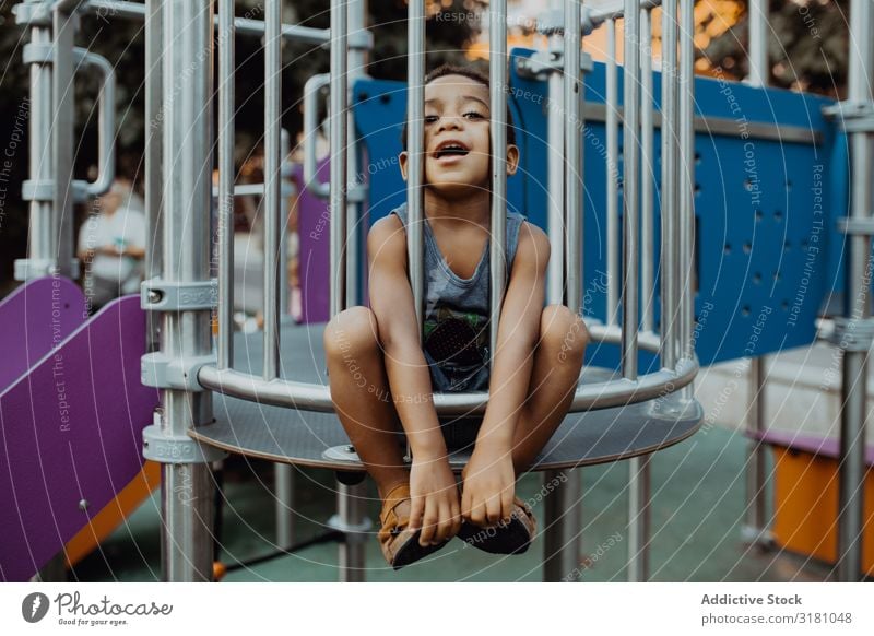 Funny black boy on playground Boy (child) Playground Park Black Grating Child Small Cute Playing Lifestyle Leisure and hobbies Rest Relaxation Entertainment