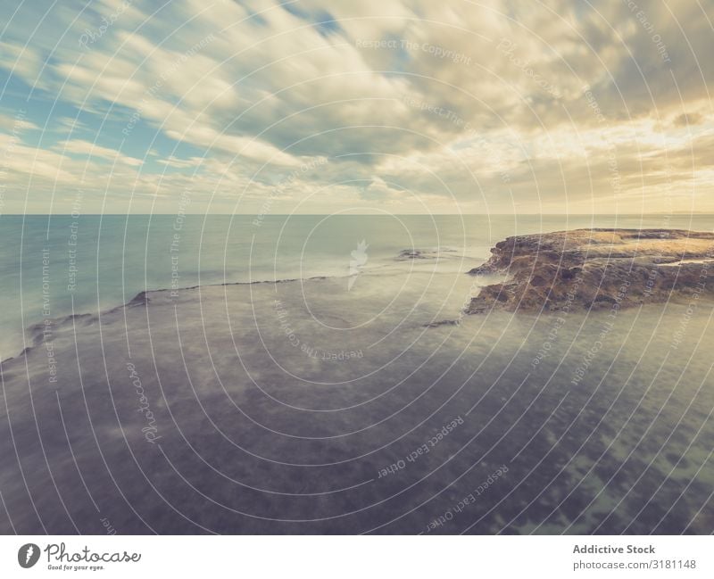 Rocky seashore under blue sky Coast Ocean Landscape Sky Dusk cloudscape Stone marine Clouds Ripple Weather Horizontal Exterior shot Copy Space Waves Nature