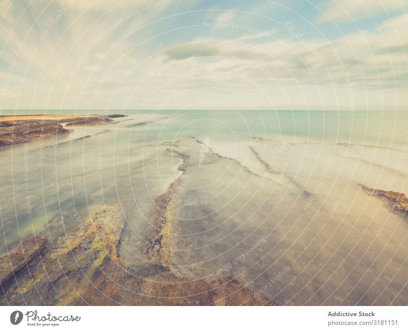 Rocky seashore under blue sky Coast Ocean Landscape Sky Dusk cloudscape Stone marine Clouds Ripple Weather Horizontal Exterior shot Copy Space Waves Nature