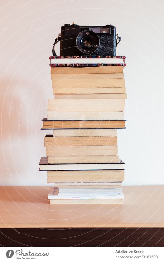 Vintage camera on top of a stack of books Camera Old Book Stack Conceptual design Antique Retro Style Photography Vacation & Travel Design Wood Top Lens Art