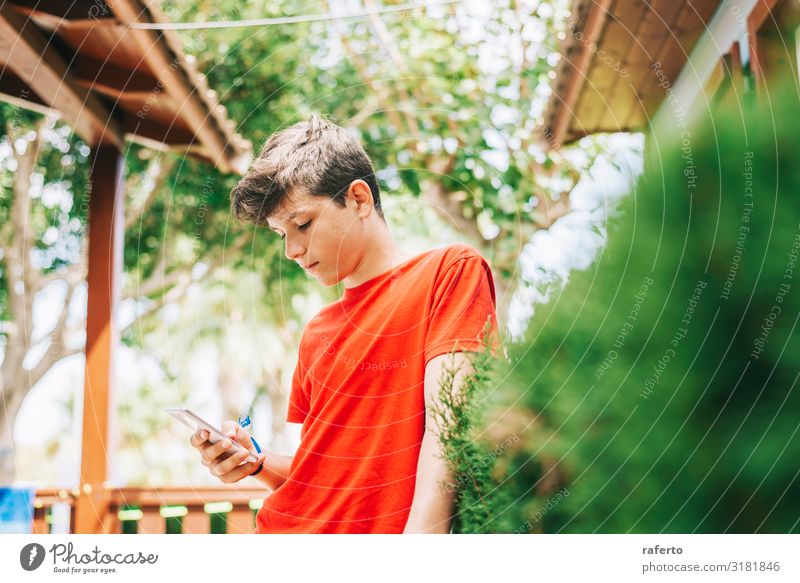 Profile of a happy male teen texting on a smart phone Happy Telephone Cellphone PDA Human being Masculine Boy (child) Man Adults Youth (Young adults) Hand 1