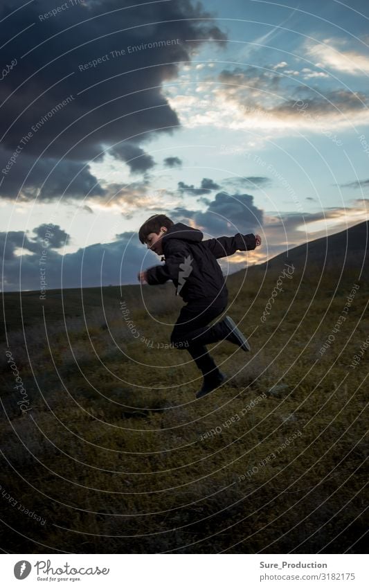 the boy is jumping against the background of the evening horizon Joy Playing Entertainment Boy (child) Family & Relations Infancy Nature Landscape Horizon