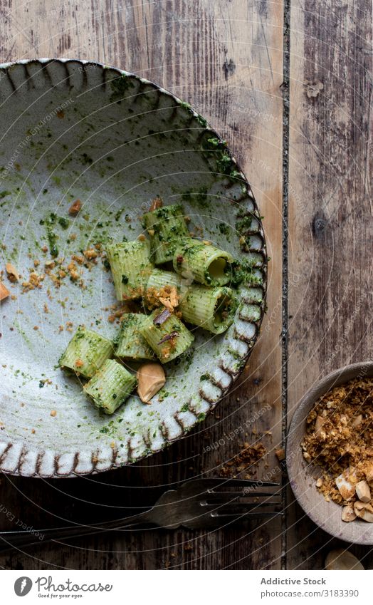 Pasta paccheri with kale pesto and nuts peanuts Kale Bowl Portion Table Italian Home-made Green Dinner Fresh Tradition Lunch Fork served Cooking Preparation