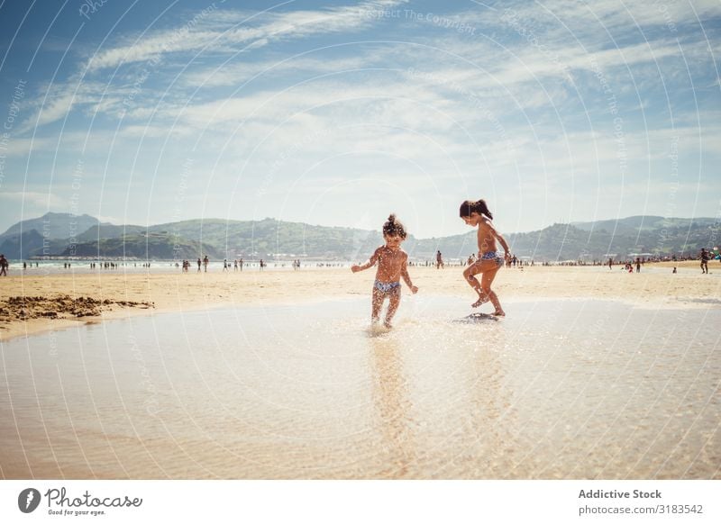 little girls by the seashore Beach Family & Relations Child Splash Joy Summer Happy Vacation & Travel Water Ocean Girl Human being Lifestyle Playing Nature Sun