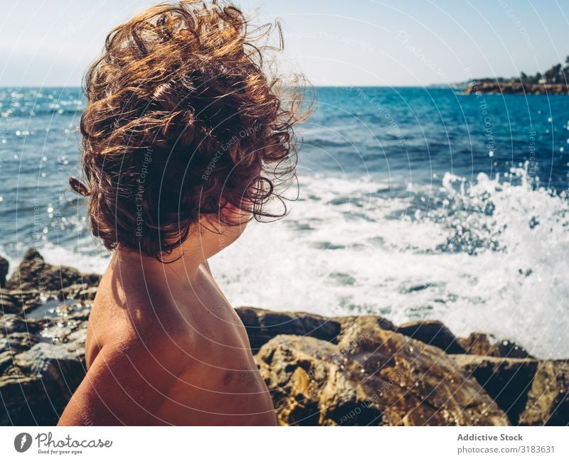 anonymous little girl by the beach Girl Anonymous Beach Back seaside Summer Vacation & Travel Child Baby Coast Sit Ocean Vantage point Exterior shot White