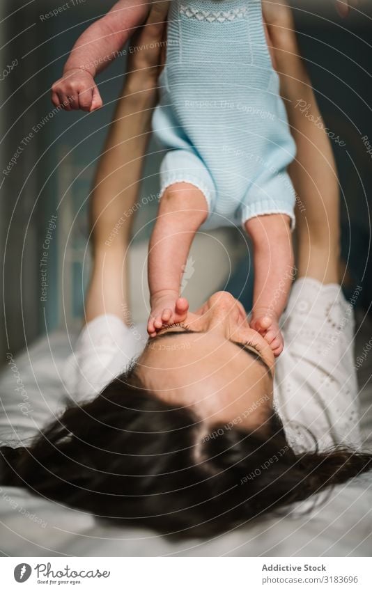 Mother playing with baby on bed Baby Bed Considerate tender Family & Relations Love Woman Child Newborn Harmonious Idyll Innocent Calm tranquil Serene Peaceful