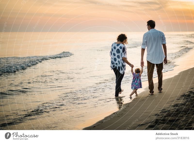 Family walking on beach Family & Relations Walking Couple Beach seaside Vacation & Travel Parents Son Ocean Summer Sand Water Child Joy Together Coast Nature