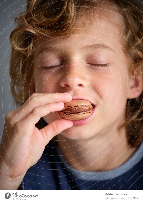 closed eyes boy enjoying tasty macaron Sweet Filling Set Kitchen Desk Sugar Cake Fresh Horizontal Round Baking Delicious yummy Bright Meal stuffing