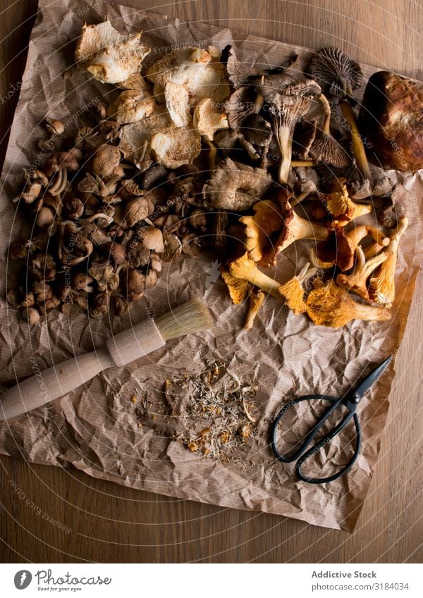 Brush and scissors near dried mushrooms Mushroom Dried parchment Paper Scissors Table Ingredients Food Natural Edible Fresh Vegan diet Healthy Organic Diet