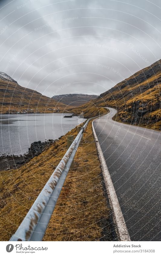 Winding road on hilly terrain Street Hill Landscape Clouds Sky Føroyar Vacation & Travel Asphalt Weather Nature Rural Deserted Lanes & trails way Track