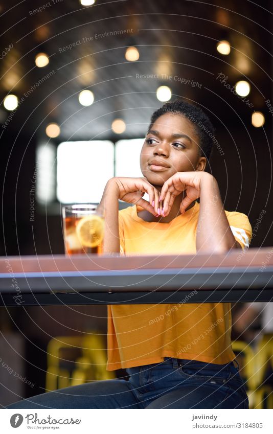 Young black woman very short hair taking a glass of cold tea. Tea Lifestyle Style Happy Beautiful Hair and hairstyles Face Table Restaurant Human being Feminine