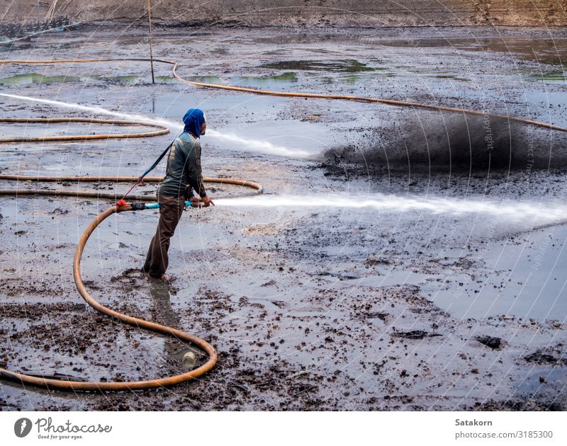 Cleaning the mud at the bottom of pond Work and employment Human being Man Adults Body 1 30 - 45 years Nature Landscape Pond Dirty Wet Natural Black Mud