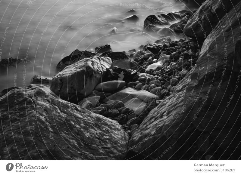 Stones in the beach Nature Landscape Elements Earth Water Summer Waves Coast Beach Bay Infinity Beautiful Wet Natural Speed Gloomy Wild Black White Silken