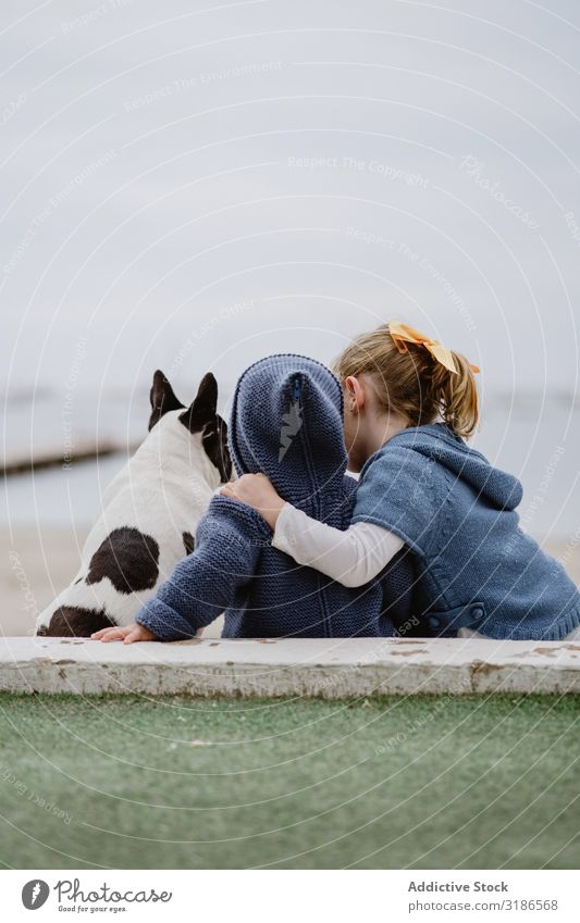 Kids hugging dog on beach Child Dog Beach Friendship Love Embrace Pet Ocean Sit Obedient Baby french bulldog Easygoing Lifestyle Leisure and hobbies embracing