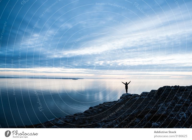 Happy man on rocky coastline Man Jump Joy Ocean Human being Excitement Wales Happiness achievement Energy Action Positive triumph Freedom Recklessness Fly