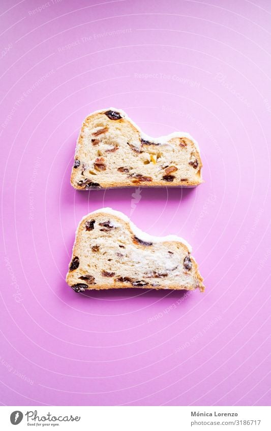 Stollen slices on pink background. Fruit Bread Dessert Herbs and spices Winter Feasts & Celebrations Pink Tradition blogging Sugar ginger Cinnamon anise recipe