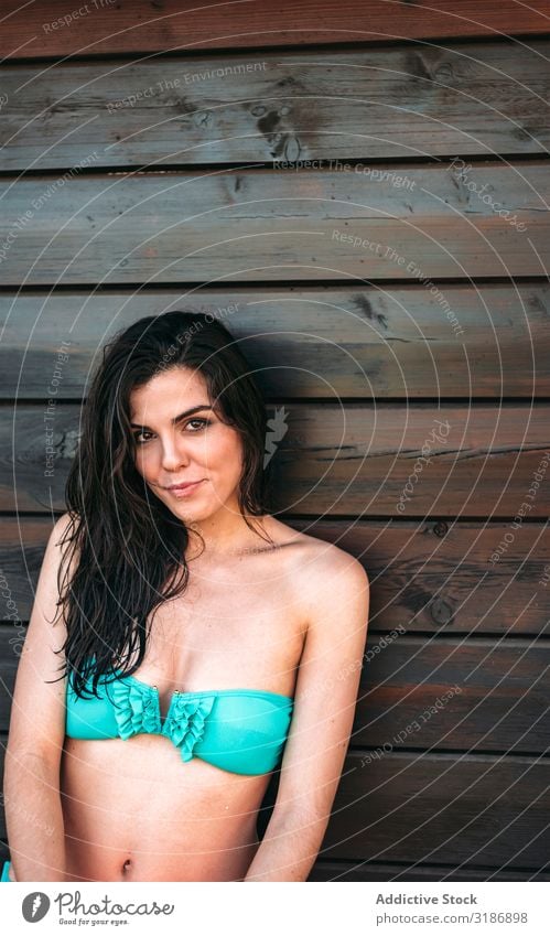 Young woman posing by wooden wall Girl Posture Wall (building) Wet Hair Bikini Smiling Attractive Contentment pretty Summer To enjoy Vacation & Travel Wood glad