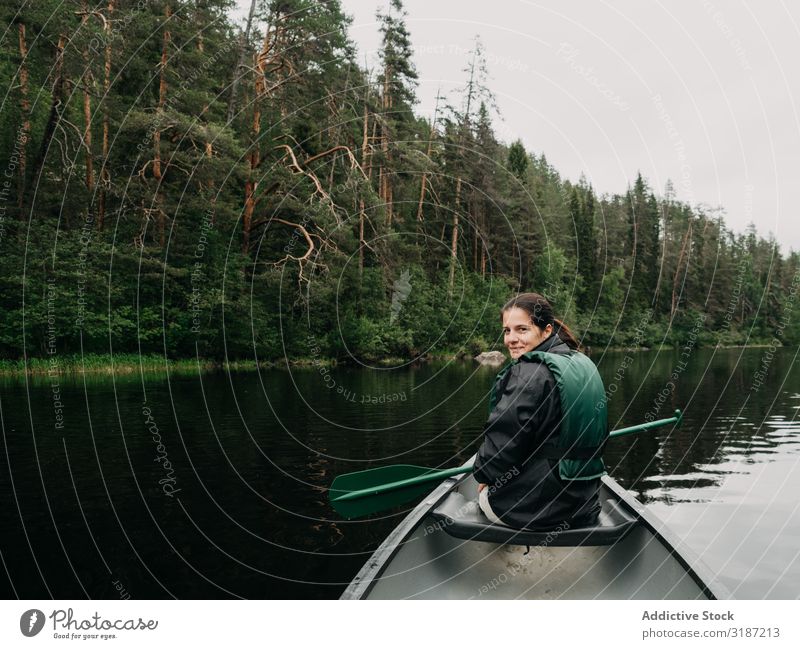 Woman boating on forest river in Finland River Vacation & Travel Lifestyle Summer Oar life vest Youth (Young adults) Watercraft Joy Human being Adventure