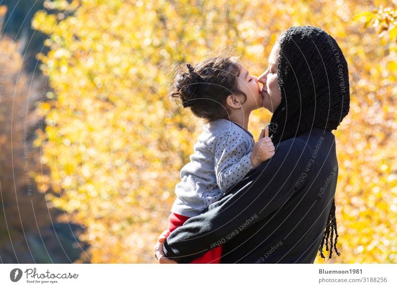 Autumn season nature scene with young mother and a little girl in her hug Orange Lifestyle Joy Happy Beautiful Relaxation Vacation & Travel Child Feminine Girl