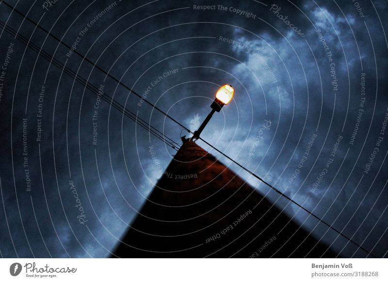 Street lamp at night Sky Clouds Road traffic Crossroads Colour photo Exterior shot Copy Space left Copy Space right Copy Space top Twilight Light Shadow