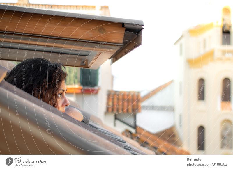 Young woman contemplating the city from the window of an attic Lifestyle Beautiful Wellness Harmonious Relaxation Meditation Vacation & Travel Trip