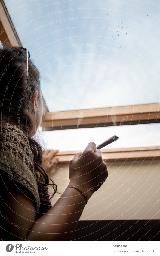 Thoughtful young woman smoking a marijuana joint. Pot Lifestyle Style Health care Alternative medicine Smoking Intoxicant Wellness Harmonious Relaxation Calm