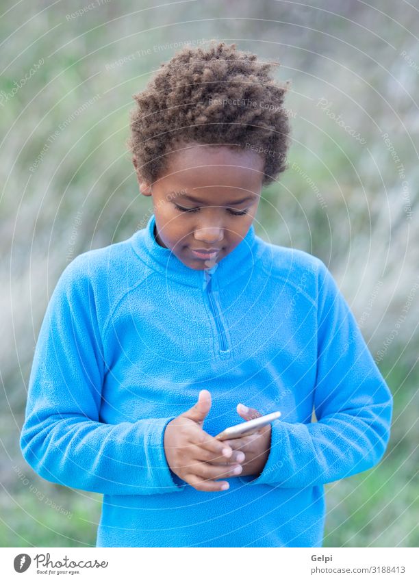 Adorable african child with a mobile phone Joy Happy Beautiful Face Child Telephone PDA Human being Infancy Nature Landscape Fashion Afro To enjoy Smiling